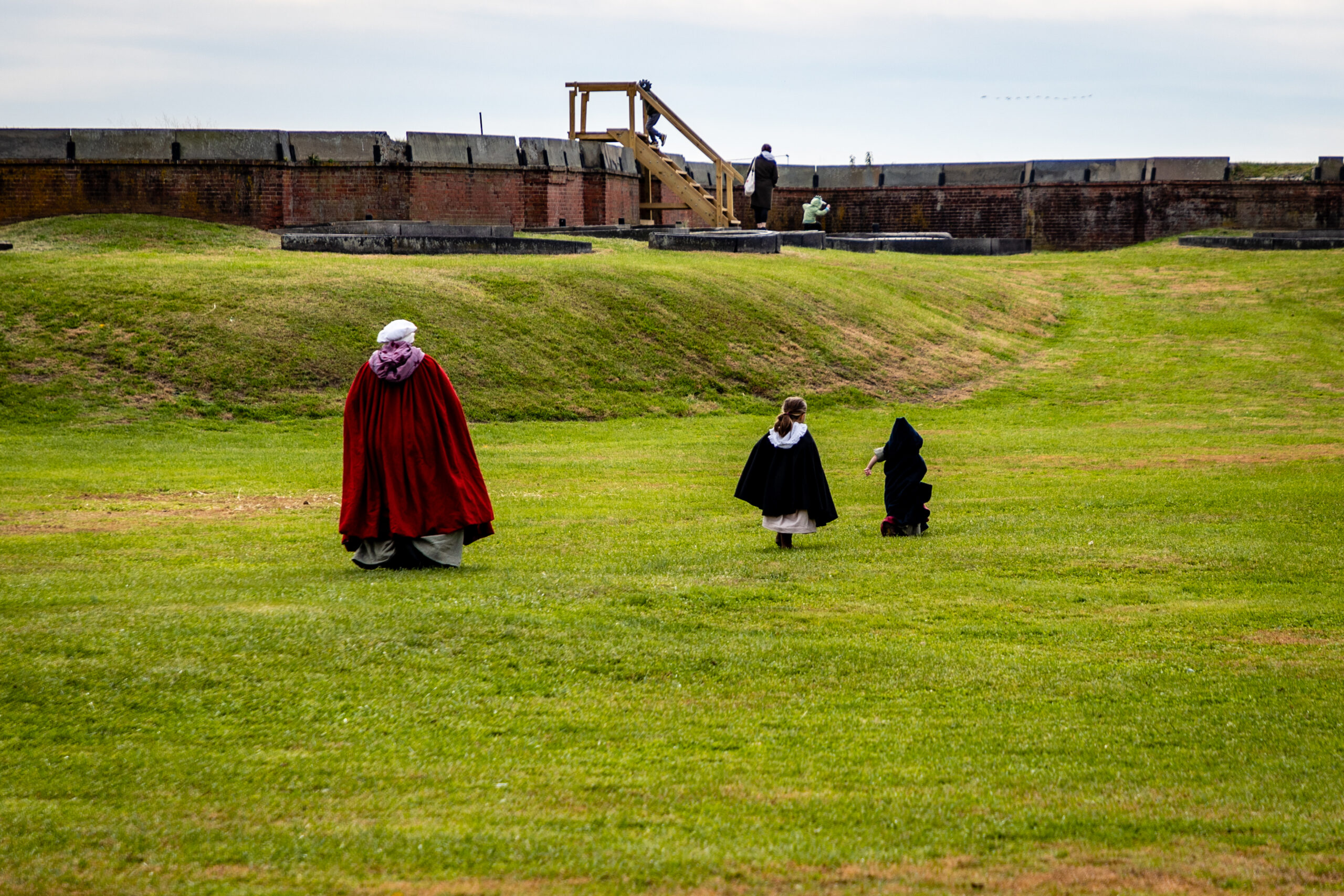 Mother and Children walking across the parade ground in colonial attire